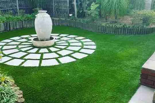sleek water feature made of dark stone pavers
